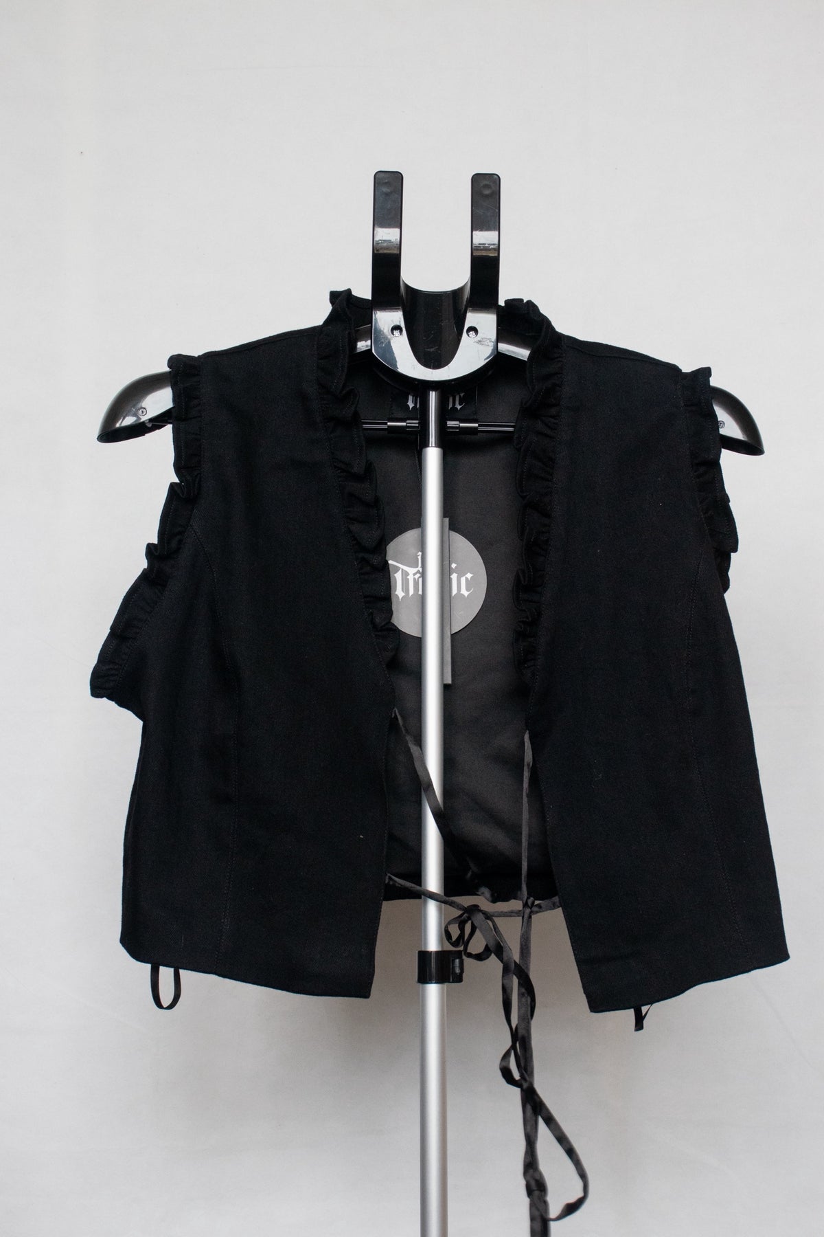 Black lace up vest with embroidered heart on back