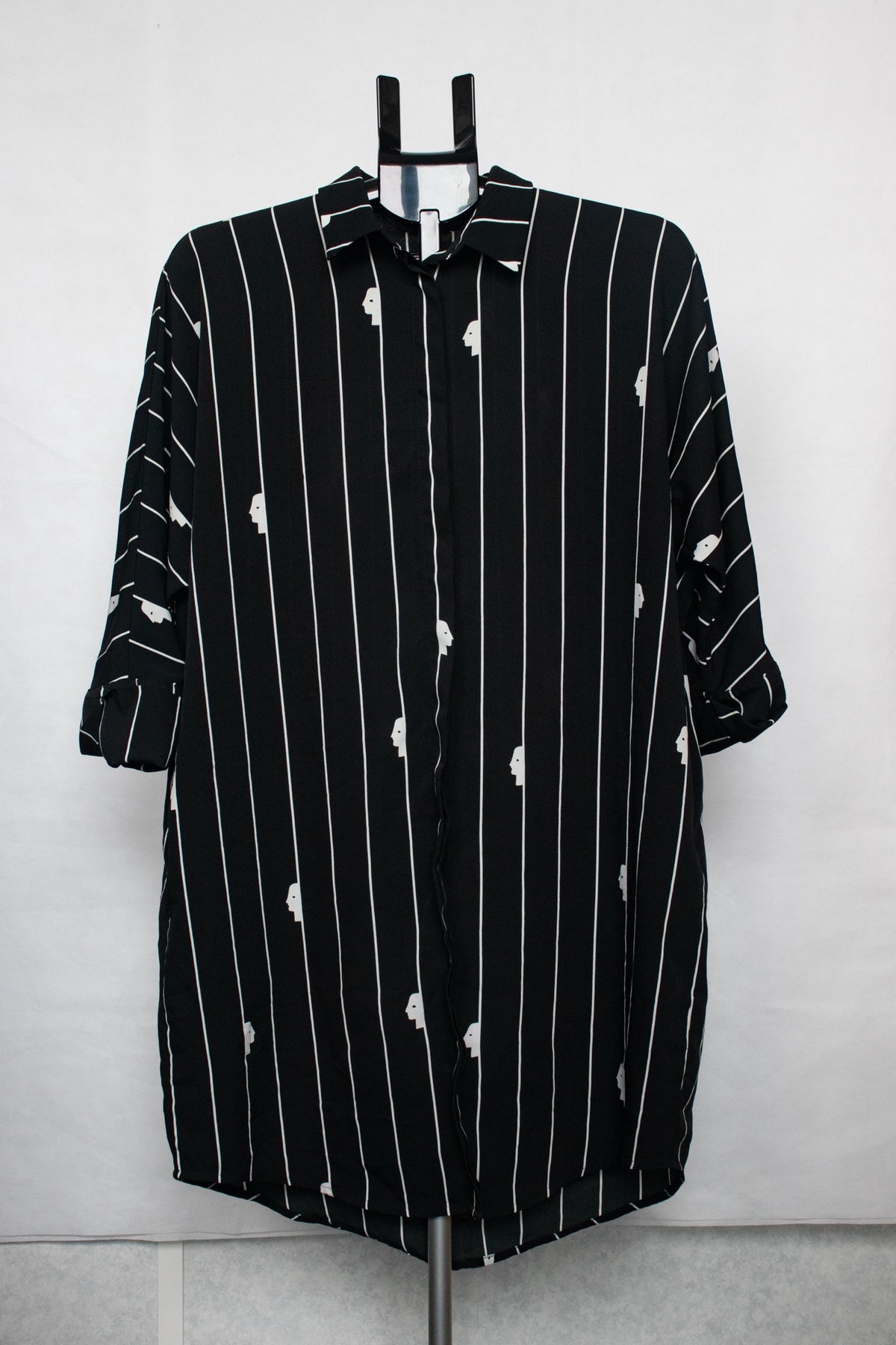 Black shirt with white stripes and faces