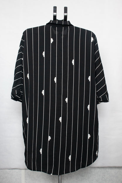 Black shirt with white stripes and faces